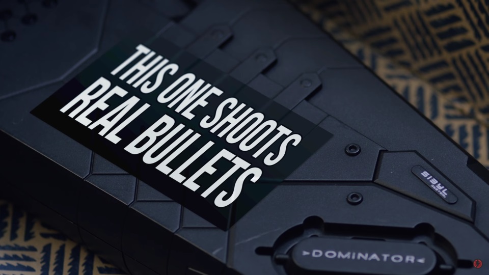 Gun with a sticker saying 'This one shoots real bullets'.